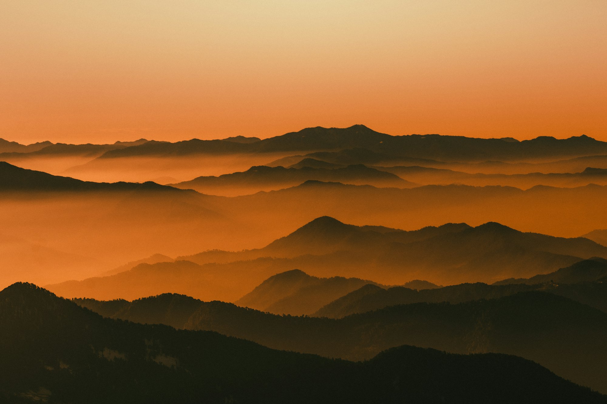 Layered mountains at golden dusk
